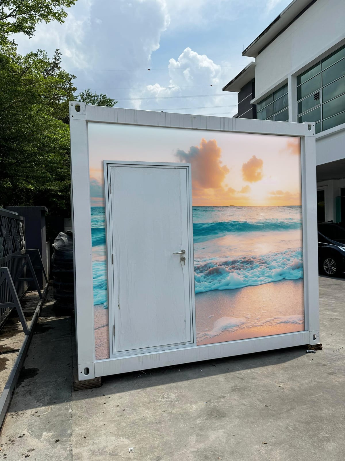 EQool event cabin toilet wrapped with a pastel sunset and turquoise waves mural